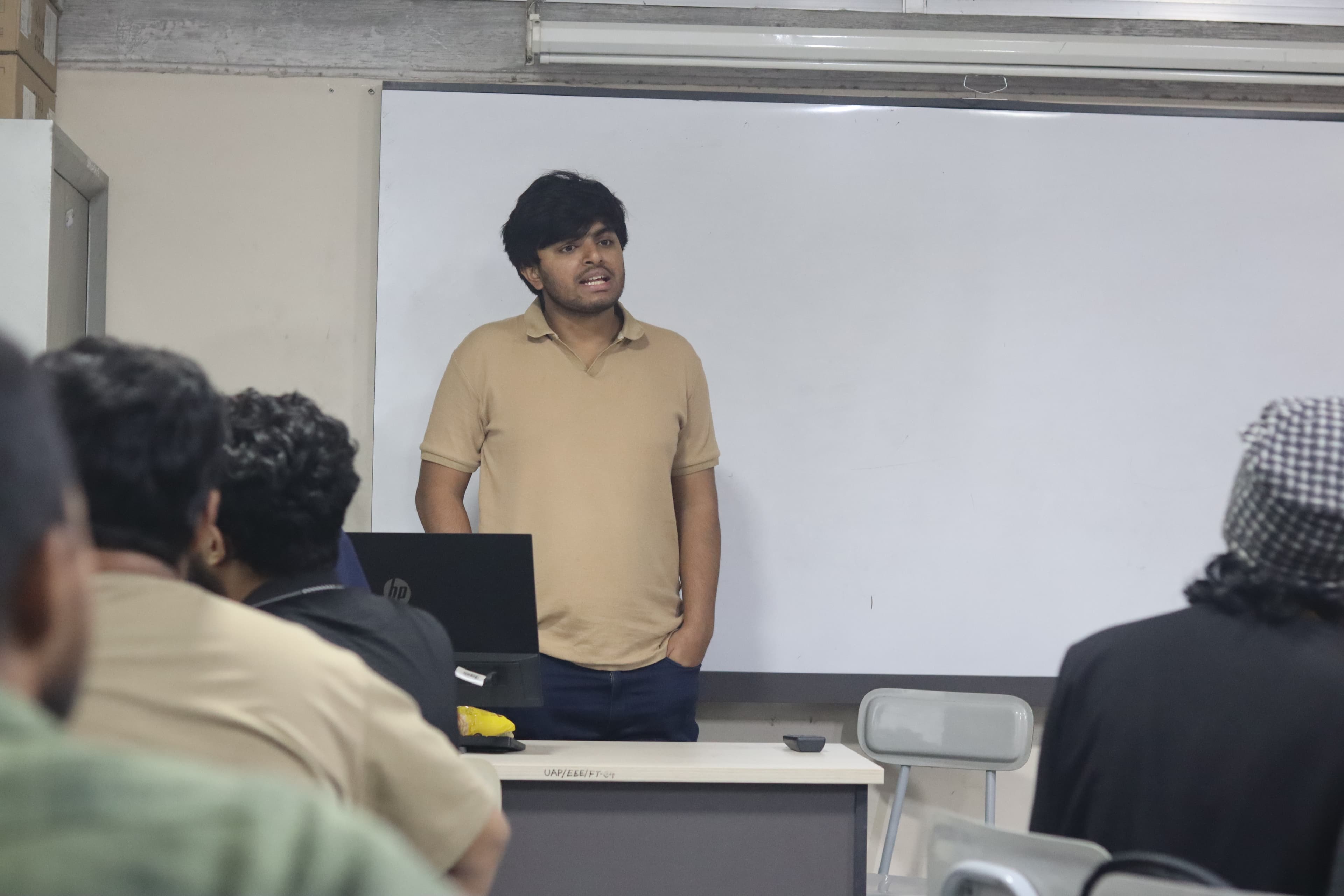 Samiul Alam Shajal presenting to a group during Paboya Group's early IT chapter